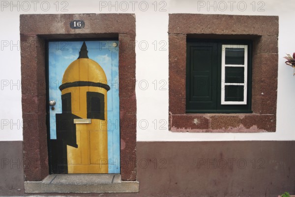 House wall with colourfully painted door, Madeira