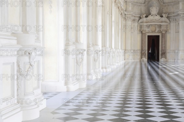 Reggia di Venaria Reale, Italy, October 2022: corridor perspective, luxury marble, gallery and windows, Royal palace, Europe