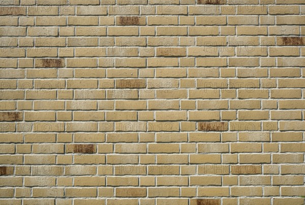 Background made from a wall of beige clinker bricks