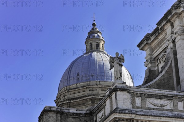 Basilica Santa Maria degli Angeli, Assisi, Umbria, Italy, Detail of an imposing dome with a statue in front of a clear blue sky, Assisi, Umbria, Italy, Europe