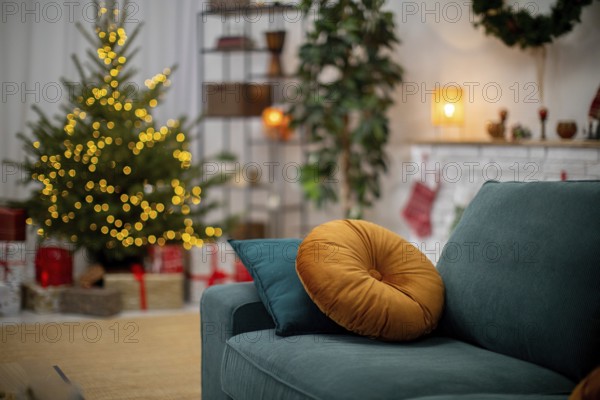 A festive living room with a decorated Christmas tree, soft couch, and delightful holiday decor throughout