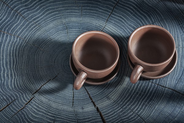 Two Empty Clay Coffee Cups On Wooden Background
