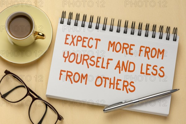 Expect more from yourself and less from others - inspirational handwriting in a sketchbook, a flat with coffee and glasses, people skills, relationships, and personal development concept