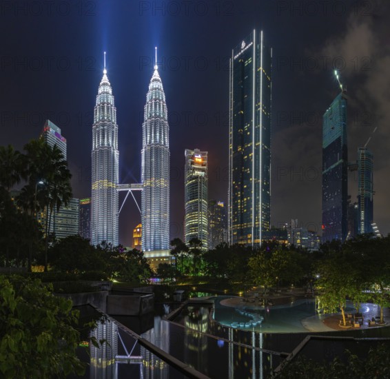 A picture of the Petronas Twin Towers as seen from the KLCC Park at night