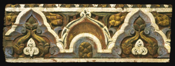 The panel's pattern achieves a fine balance between serving as a geometric border and comprising a vegetal ornament with recognizable elements such as pinecones and leaves. The wooden panel perhaps embellished a lintel in a well-to-do private house