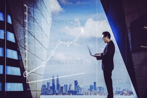 Businessman using laptop with graph statistical analysis, Business success concept