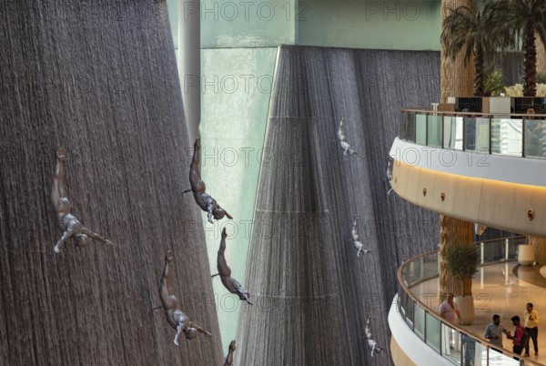 A picture of the Dubai Mall waterfalls and sculptures that decorate one of the many atriums of the large shopping center