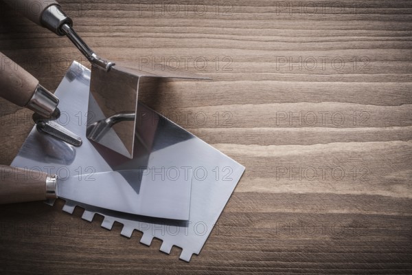 Scraper surfacer putty knife on wooden board