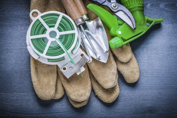 Set of garden tools on protective glove
