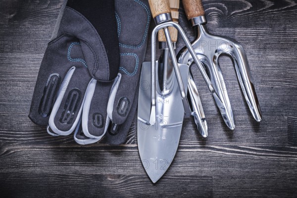 Stainless shovel rake trowel fork safety gloves gardening concept