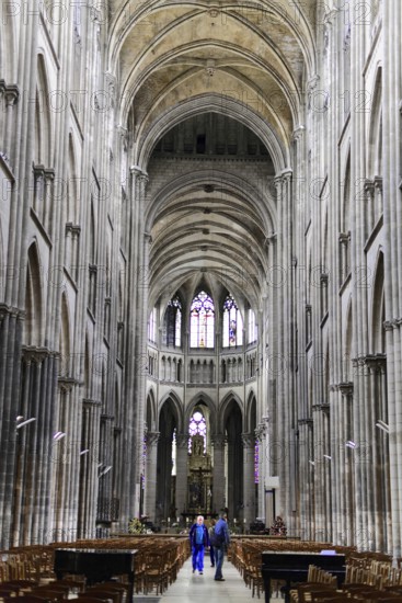 Rouen Cathedral, Rouen, Département Seine-Maritime, Region Haute-Normandie, France, Europe, Majestic gothic interior of a cathedral with high vaults and a visitor, Seine-Maritime, Haute-Normandie, Europe