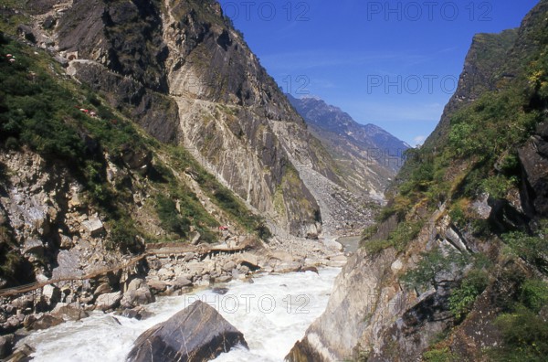Tiger Leaping Gorge is located north of Lijiang. The Yangtze (Yang Zi) River flows through the canyon. The gorge is part of the Three Parallel Rivers of Yunnan Protected Areas World Heritage Site.<br/><br/> The river cuts between Jade Dragon Snow Mountain (5, 596 m) and Haba Snow Mountain (5, 396 m) forming Tiger Leaping Gorge