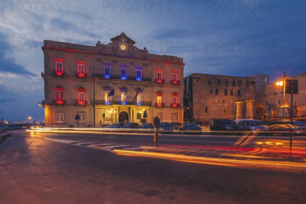 Awesome seaside of Taranto in the evening. A big city in southern Italy with an industry port. Empty streets in lights of a beautiful cityside with a breathtaking architecture