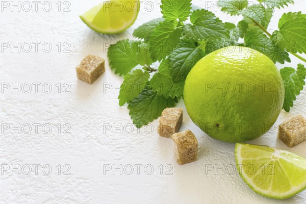 Ingredients for Mojito. Juicy lime, mint and brown sugar, copy space