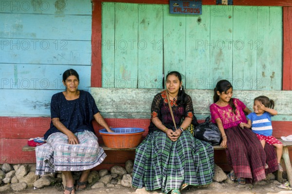 Women in front of a colorful wall, Lancetillo, La Parroquia, Reyna area, Quiche, Guatemala, Central America