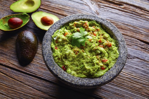 Avocado Guacamole on molcajete real Mexican traditional procedure