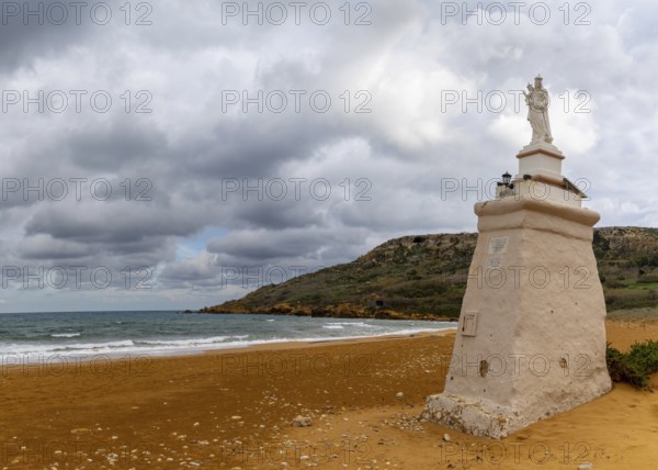 Ramla Bay, Malta, 20 December, 2023: view of the red sand beach and Staue of Our Lady in Ramla Bay on Gozo Island in Malta, Europe