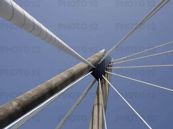 A geometric close up of the supports and cables of the suspension bridge in southport merseyside against a blue sky