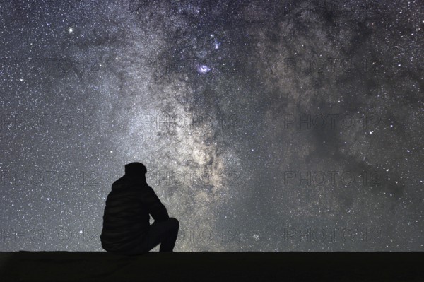 Man looking at the stars. Alone man looking at starry sky. Night sky