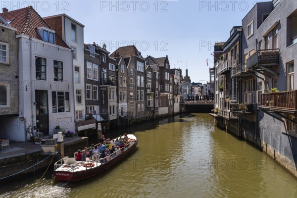 Dordrecht, Netherlands, May 8, 2022: Scenic view of the old town of Dordrecht in Western Netherlands. Tour boat with tourists in the canal