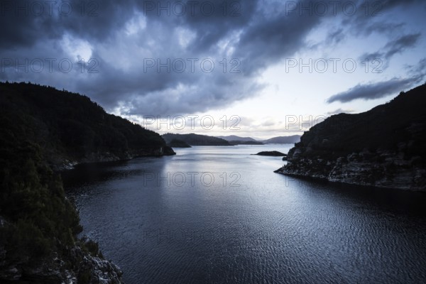 View of the Gordon Dam on a cool summer's day. It is a unique double curvature concrete arch dam with a spillway across the Gordon River near Strathgordon, South West Tasmania, Australia, Oceania