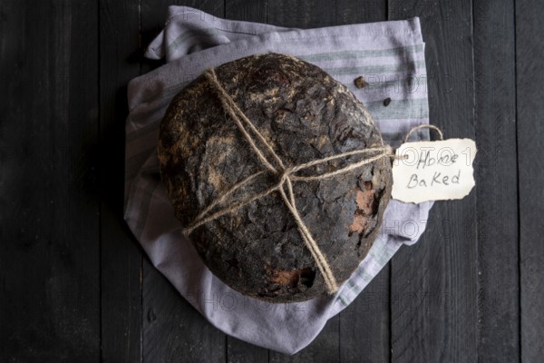 Fresh baked homemade bread on a black wooden table. Above view image