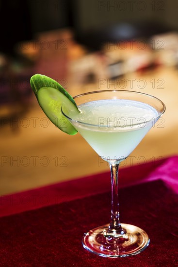 Modern blue martini cocktail with lime in bar