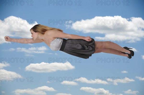 Beautiful young woman flying through the sky
