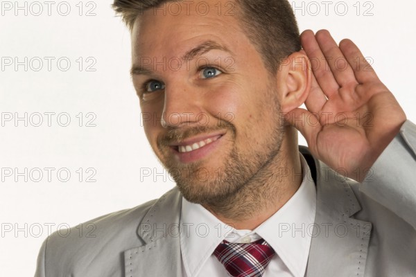 A man (entrepreneur or manager) holds his hand to his ear Austria