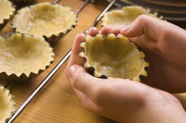Detail of child hands making cookies, lodz, poland