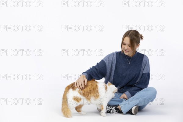 A joyful moment shows a woman petting her cat, highlighting their bond and the love between pets and humans