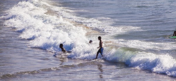 People swim, surf and play in the water
