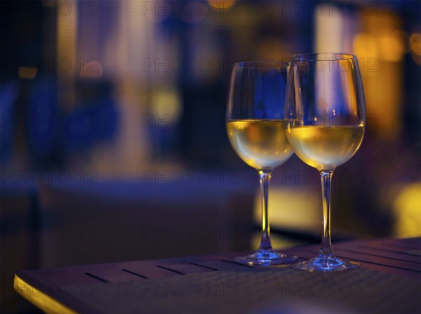 Two glasses of the white wine in the night. Close up. DOF