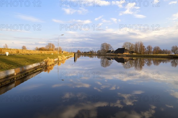 Dutch farmhouse by wide river, Groningen