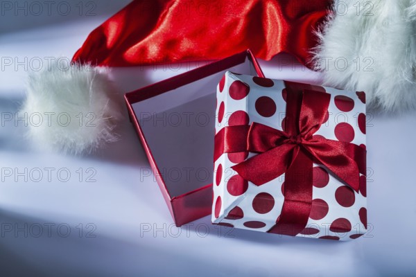 Santa hat wrapped gift box on white background