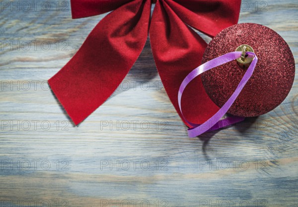 Set of red Christmas bow ball on wooden board holidays concept