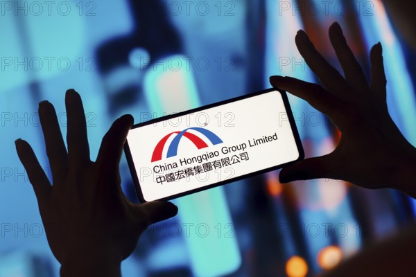 In this photo illustration, the China Hongqiao Group Limited logo is displayed on a smartphone screen