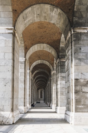 Madrid, Spain, May 16, 2023: Arcade of Royal Palace in Madrid in a sunny spring day, Europe