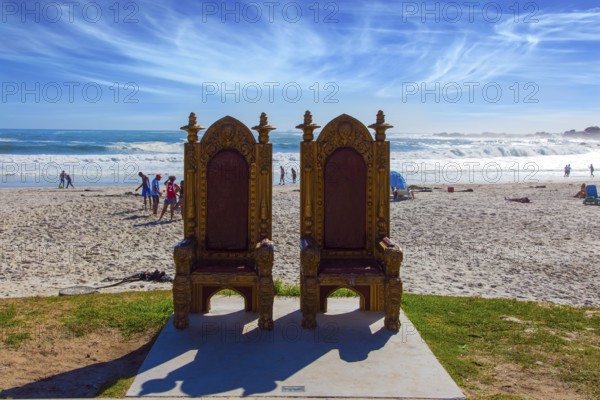 Two magnificent decorative chairs for tourist photography on the beach. Promenade and beach in fabulous port city Cape Town. The concept of active, exotic and photo tourism