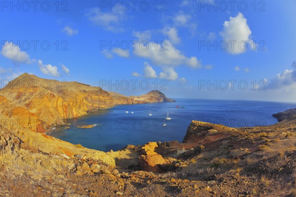 White yachts lit sunset. Quiet ocean cove on the island of Madeira. Calm on the Atlantic Ocean