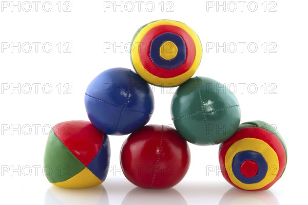 Many colorful juggle balls with stripes isolated over white