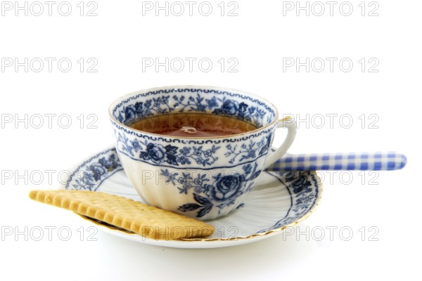 Cup of tea with a cookie isolated over white