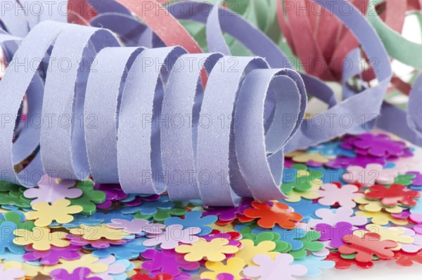 Paper colorful party streamers on tiny flowers