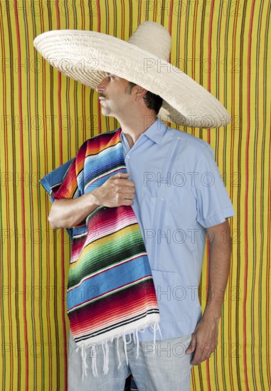 Mexican man serape poncho hat sombrero yellow stripes background