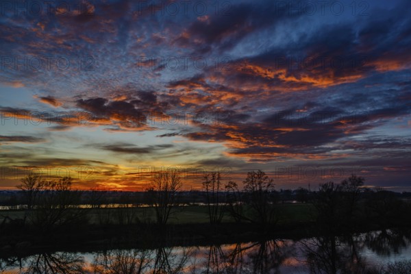An atmospheric sunset with bright colours and a beautiful reflection in the water, Bogen, Lower Bavaria