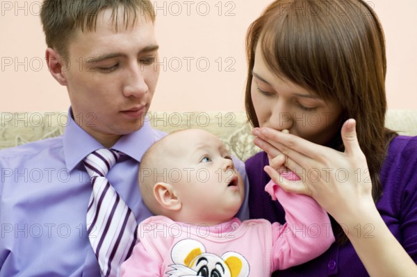 Young caucasian couple with their little baby