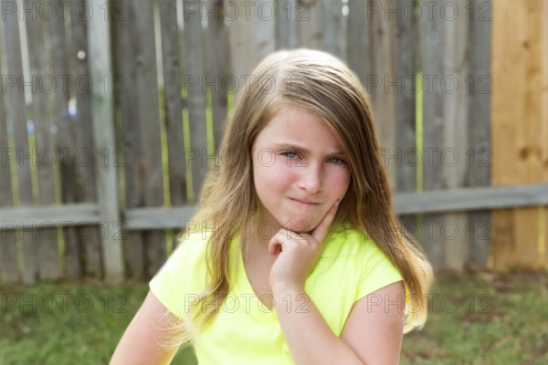 Kid girl with disappoint expression finger thinking expression outdoor