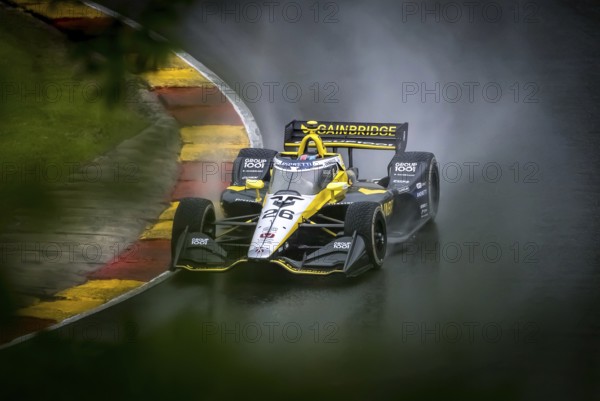 COLTON HERTA (26) of Valencia, California comes through turn 12 (Canada Corner) during a wet practice session for the XPEL Grand Prix at Road America in Elkhart Lake, WI