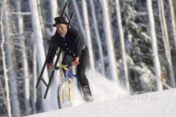 Chimney sweep on a mountain bike in winter, chimney sweep, chimney sweep