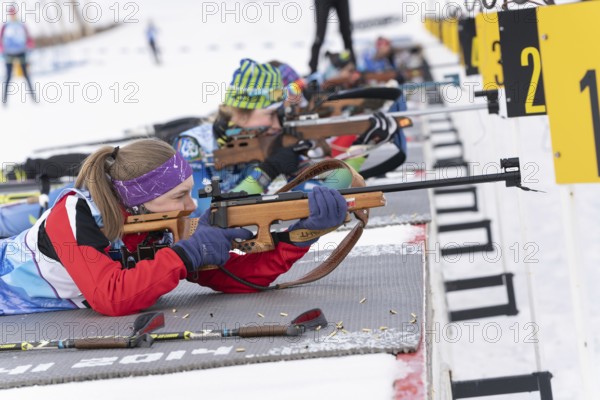Kamchatka sportswoman biathlete Valentina Vakhrusheva rifle shooting in prone position. Biathlete in shooting range Open regional youth biathlon competitions East Cup. Kamchatka, Russia, Apr 12, 2019, Europe